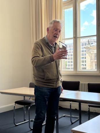 man holding manuscript while presenting