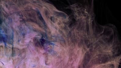 photograph of pink and blue smoke merging with each other on a black background