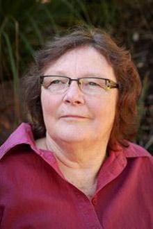 profile picture of Helen R. Verran wearing a red blouse and glasses